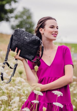 Black handbag with a textured, quilted pattern and silver hardware. Adjustable strap and logo detail featured on the front.