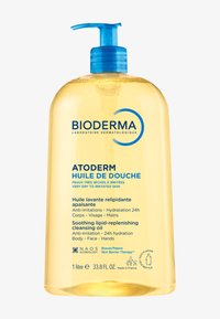 Huile nettoyante Bioderma Atoderm dans un flacon transparent avec pompe. Liquide jaune visible, avec du texte et des accents bleus mettant en valeur les détails du produit.