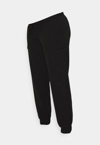 Calças de jogging pretas feitas de tecido macio, com um cós elástico, bolsos laterais e punhos ajustados nos tornozelos.