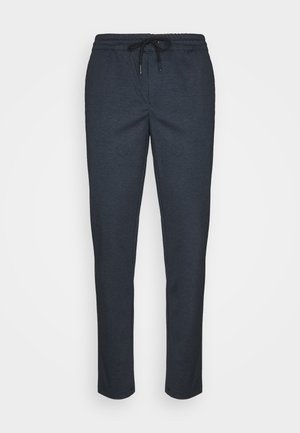 Pantalons de jogging texturés bleu marine avec taille élastique et cordon de serrage ajustable. Design à jambe fuselée sans poches visibles.