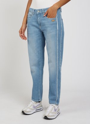 Light blue denim jeans with a straight cut, featuring a distressed side seam detail and classic five-pocket design, paired with white sneakers.