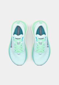 Light blue running shoes with a breathable texture, mint green accents, flat laces, and a padded collar. Features HOKA branding.