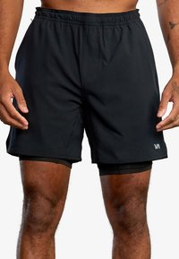 Black athletic shorts with an elastic waistband, featuring a fitted inner layer and a small white logo on the lower hem.