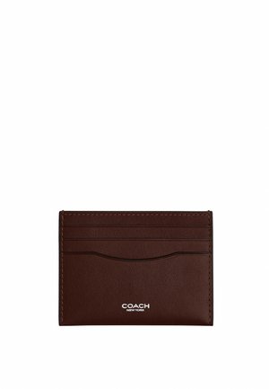 Porte-cartes en cuir marron foncé avec quatre emplacements pour cartes et logo blanc « COACH NEW YORK » centré en bas.