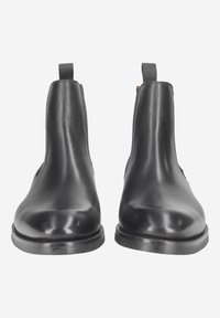 Schwarze Chelsea-Stiefel aus Leder mit glattem Finish, abgerundeter Zehenpartie, elastischen Seitenteilen und Schlaufen an der Rückseite. Flache Gummisohlen.