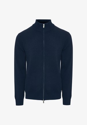 Pull à zip bleu marine avec un col montant, fabriqué en tissu tricot lisse. Il présente des manches longues ajustées ainsi qu'un ourlet et des poignets côtelés.