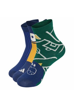 Tre calzini alla caviglia colorati con disegni di mostri e volti astratti in blu, giallo e verde mostrati uno accanto all'altro.