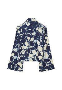 Chemisier court à manches longues avec imprimé floral bleu marine et blanc, large poignets et col pointu, vu de dos.