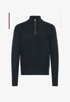 Tummanharmaa neulepusero, jossa on korkea kaulus ja neljännesvetoketju. Varren ja helman ribboitettu rakenne lisää tekstuuria kokonaisuuteen.