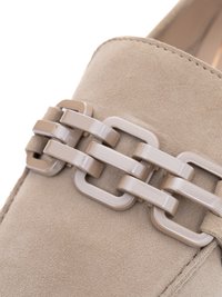 Beige suede loafer with a decorative beige plastic chain link detail across the top.