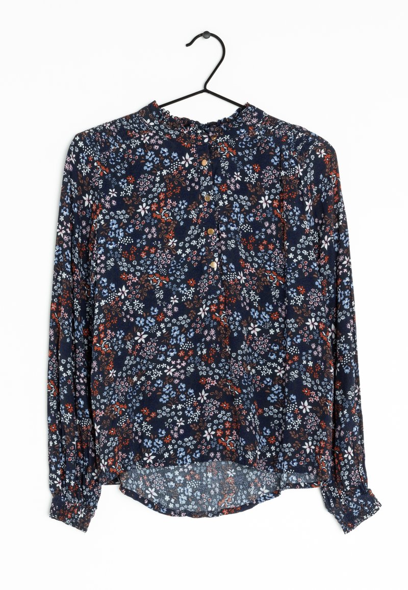 Tummansininen pitkähihainen kukkaitaideteos, jossa on frilla kauluksessa, nappikiinnitys edessä ja sekoitus punaisia, valkoisia ja vaaleansinisiä kukkakuoseja.