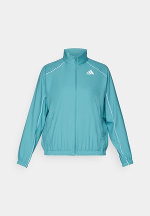 Teal zip-up jakke med ståkrage. Har hvit piping langs skuldrene og en liten logo på venstre bryst. Lett materiale.