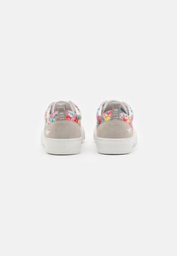 Floral-patterned sneakers with a textured gray suede heel and white rubber sole. Features elastic openings for easy wear.