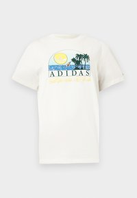 White cotton t-shirt featuring a graphic design with a sun, palm trees, and water. "ADIDAS Sports Club" printed in green and yellow.