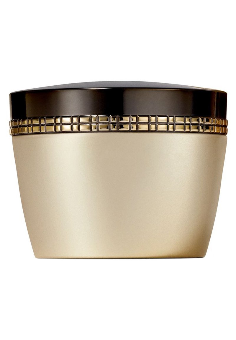 Contenitore dalla forma arrotondata, con una base dorata e un coperchio nero. Una fascia dorata decorata attorno al centro aggiunge texture e dettagli.
