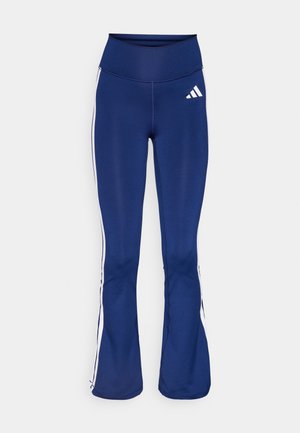 Námořnické legíny s rozšířením vyrobené z pružného materiálu, s bílými bočními pruhy a logem Adidas na levém bocích. Hladký povrch, vysoký pas.