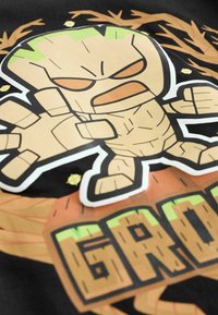 Cartoon Groot character with raised hand and clenched fist, surrounded by branches and stars, with "GROOT" text below.
