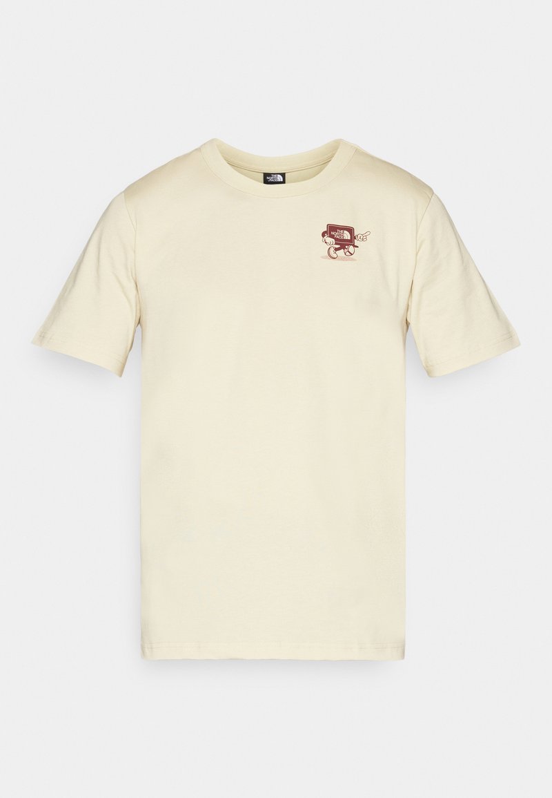 T-shirt couleur crème en coton, arborant un petit motif graphique rouge sur la poitrine gauche. Col rond et manches courtes.