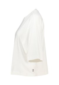 White short-sleeve oversized T-shirt with dropped shoulders, round neck, and small black side label.