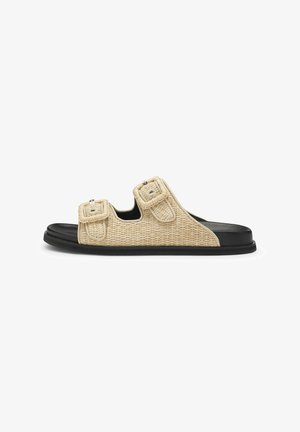 Light beige woven sandals with dual adjustable straps, black rubber sole, and textured finish. Features silver hardware on straps.