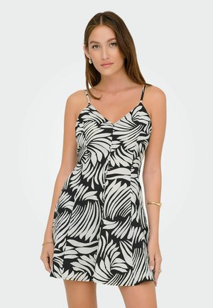 Black and white sleeveless dress featuring a leaf pattern, V-neck design, and lightweight fabric with a pleated skirt.