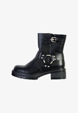 Black leather ankle boot with a round toe, chunky heel, decorative buckle, and strap with metal hardware detailing. Rubber sole for traction.