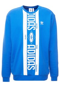 Sudadera azul de algodón, con un gran diseño gráfico blanco que muestra "ADIDAS" y un logo de diamante. Cuello redondo, puños acanalados.