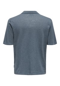 Polo de manga corta en azul pizarra, de tejido ligero y texturizado. Presenta un cuello clásico y un dobladillo limpio y recto en la parte posterior.