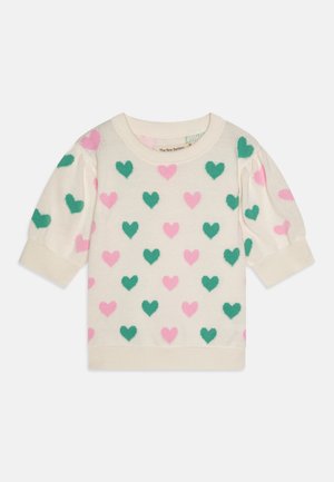 Kreminė megztinė su trumpomis pūstomis rankovėmis, dekoruota įvairaus dydžio žalių ir rožinių širdelių raštu. Švelni megztinė tekstūra.