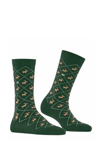 Chaussettes en coton vert avec un motif en diamant, ornées de silhouettes de cerfs marron clair et d'accents géométriques blancs. Longueur mi-mollet et texture douce.