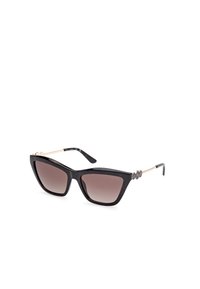 Gafas de sol de acetato negro en forma de ojo de gato con lentes marrones degradados, detalles metálicos dorados en las varillas y embellishments circulares distintivos.
