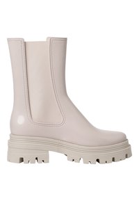 Bottines en caoutchouc beiges avec panneaux latéraux élastiques, semelle épaisse blanche et texture lisse et brillante. Design à bout carré et coutures renforcées.