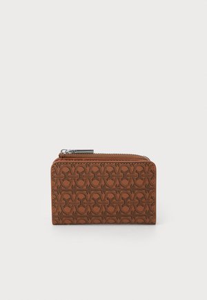 Brown zippered wallet in textured leather, featuring a geometric pattern. Compact, rectangular shape with silver hardware accent.