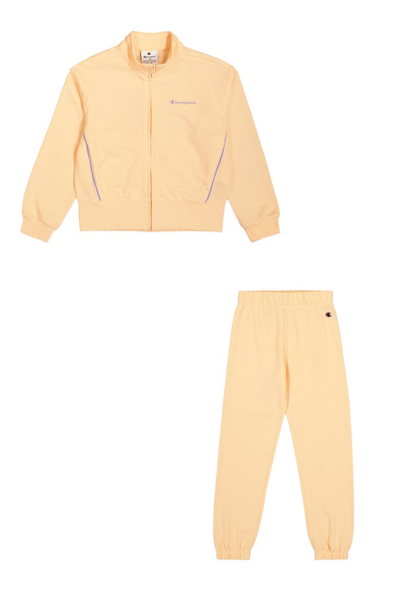 Conjunto de chándal amarillo claro que incluye una chaqueta con cremallera y acentos morados, y pantalones elásticos a juego. Tejido suave, corte relajado.