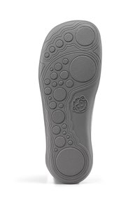 Gray shoe sole with rounded patterns and varying textures. Notable circular accents and a logo with a cartoon-like design.