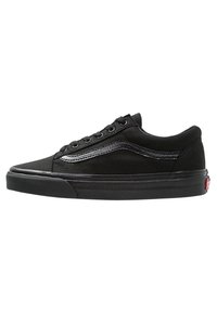Scarpe da skate in suede nero con profilo basso, dotate di una striscia laterale nera liscia, suola in gomma e lacci neri. Logo rosso sul tallone.