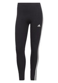 Svarta leggings med en elegant, åtsittande design. Tillverkade av stretchigt material med vita sidostripes och en Adidas-logga på vänster lår.