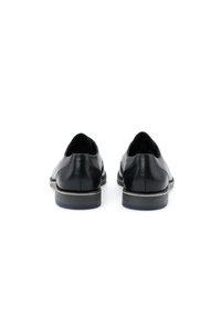 Scarpe in pelle nera con una finitura liscia. Punta rotonda, tacco basso impilato e accenti sottili a contrasto sulla suola.
