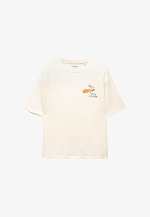 T-shirt di cotone color crema con maniche corte, presenta un design grafico di una tazza e un cornetto, con il testo "Delizioso e Irresistibile."