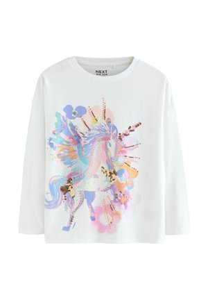 T-shirt bianco a maniche lunghe in cotone con una grafica di unicorno multicolore decorata con paillettes e motivi floreali in tonalità pastello.