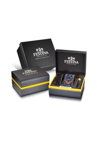 Festina-ur i en sort og gul special edition æske. Uret har en multicolorer skive, blå rem og inkluderer en ekstra sort rem.
