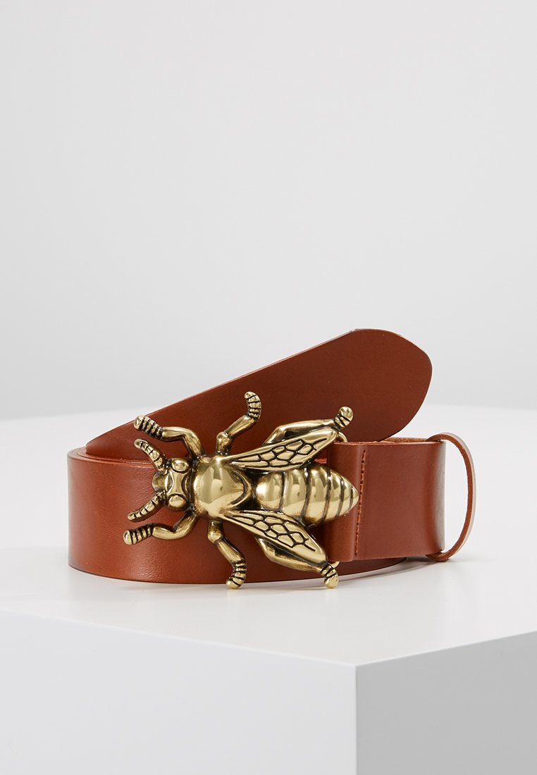 Brown leather belt with a large, detailed golden bee-shaped buckle. Smooth texture, wide strap, and an adjustable clasp.