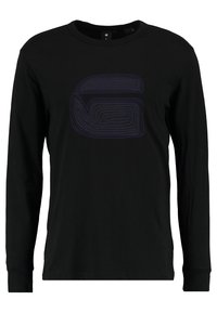 Musta pitkähihaisen t-paita, joka on valmistettu puuvillasta, pyöreällä kaula-aukolla ja tummansinisellä abstraktilla kuvioinnilla etupuolella.