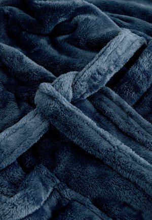 Dunkelblaues Plüsch-Wurfdecke mit einer weichen, texturierten Oberfläche, die in der Mitte ein gebundenes Design aufweist und einen sanften, flauschigen Abschluss hat.