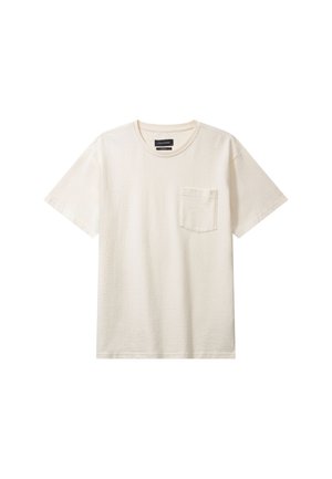 Maglietta color crema con maniche corte, scollo rotondo e taschino sul petto sinistro. Realizzata in tessuto di cotone morbido e dalla texture.