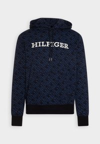 Mikina s kapucí v tmavě modré barvě s geometrickým vzorem. Obsahuje přední kapsu a bílý nápis "HILFIGER" přes hruď.