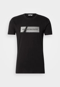 Black cotton t-shirt featuring a graphic design with the text "ANTONY MORATO" in a white rectangular pattern on the front.