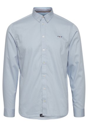 Heledat sinine pikade varrukatega särk nupuga kraega, valgete nuppudega, diskreetse logoga ja triibulise aktsendiga sisekrael. Sile tekstuur.