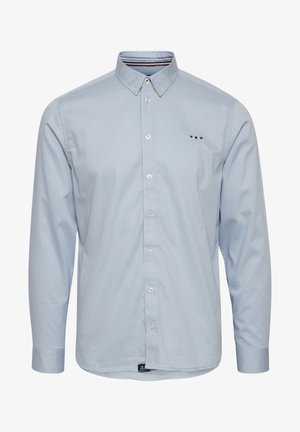 Light blue long-sleeve shirt with a button-down collar, white buttons, subtle logo, and striped accent on the inner collar. Smooth texture.