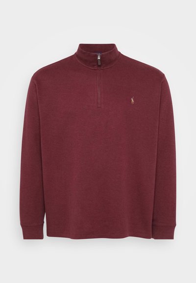 Burgundy long-sleeve pullover with a quarter-zip neck and ribbed cuffs. Features a small logo on the chest. Soft, textured material.